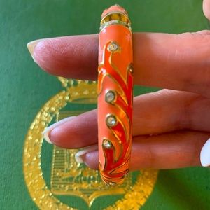 Henri Bendel coral/orange enamel bracelet in EUC. Unsigned, HB dust bag included